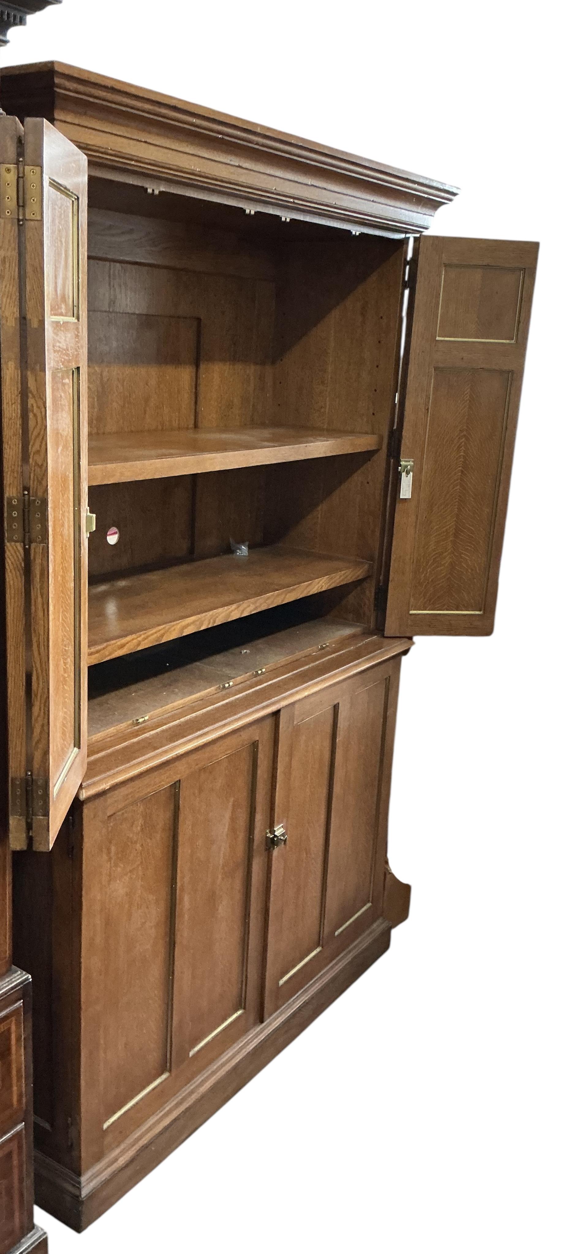 A brass mounted oak media cabinet, retailed by Ralph Lauren, upper section with bi-fold doors, width 140cm, depth 53cm, height 225cm
